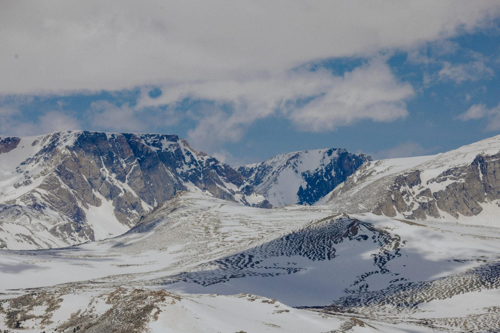 Snow-covered peaks stacked into distance