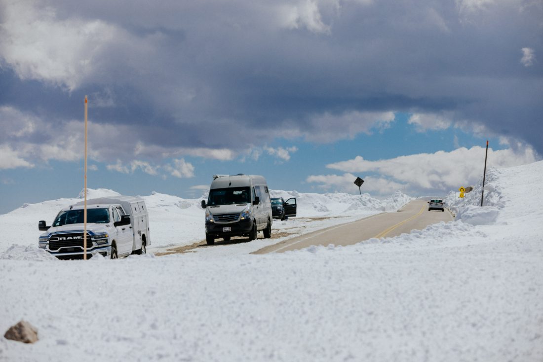 Vans running a snow-lined road in winter